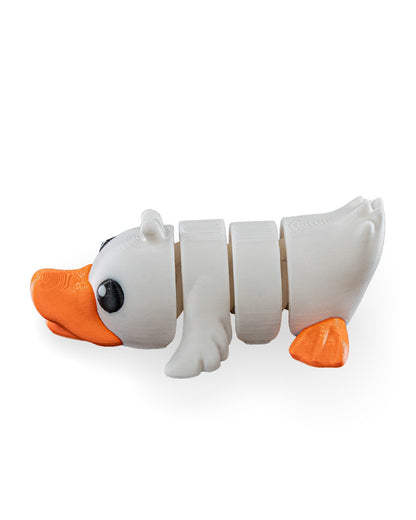 A white segmented duck toy with orange beak and feet, photographed on a clean white background.