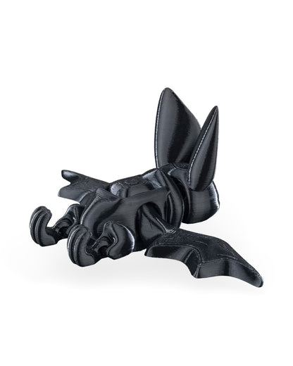 Articulated bat fidget toy shown from above with wings partly spread