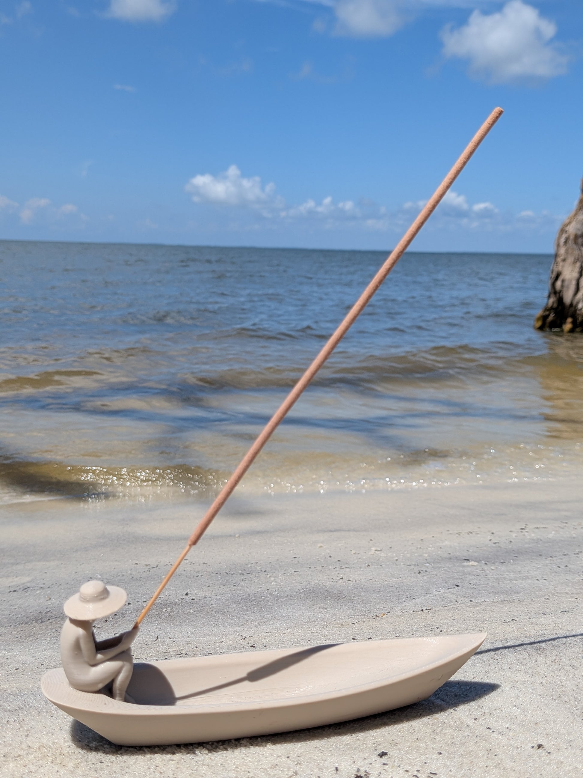 3D-printed fisherman incense holder shaped like a boat, sandy neutral finish