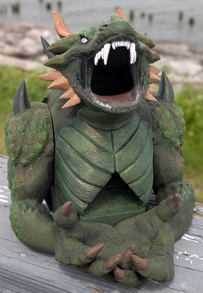 Hand-painted green devourer dice tower with open jaws and claws in its lap