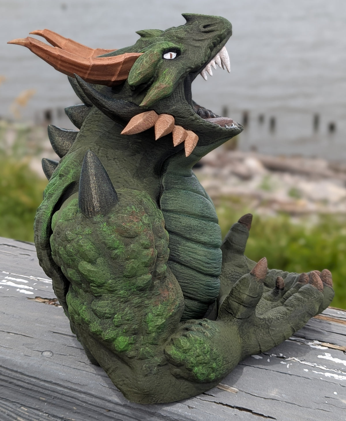 Side view of the devourer dice tower with head tilted back and horns visible