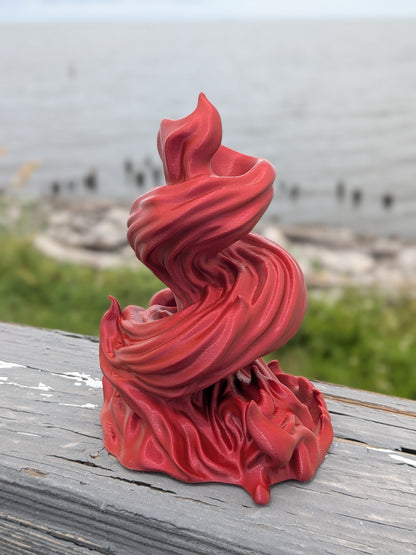 Close-up of red flame dice tower showing the twisting spiral texture