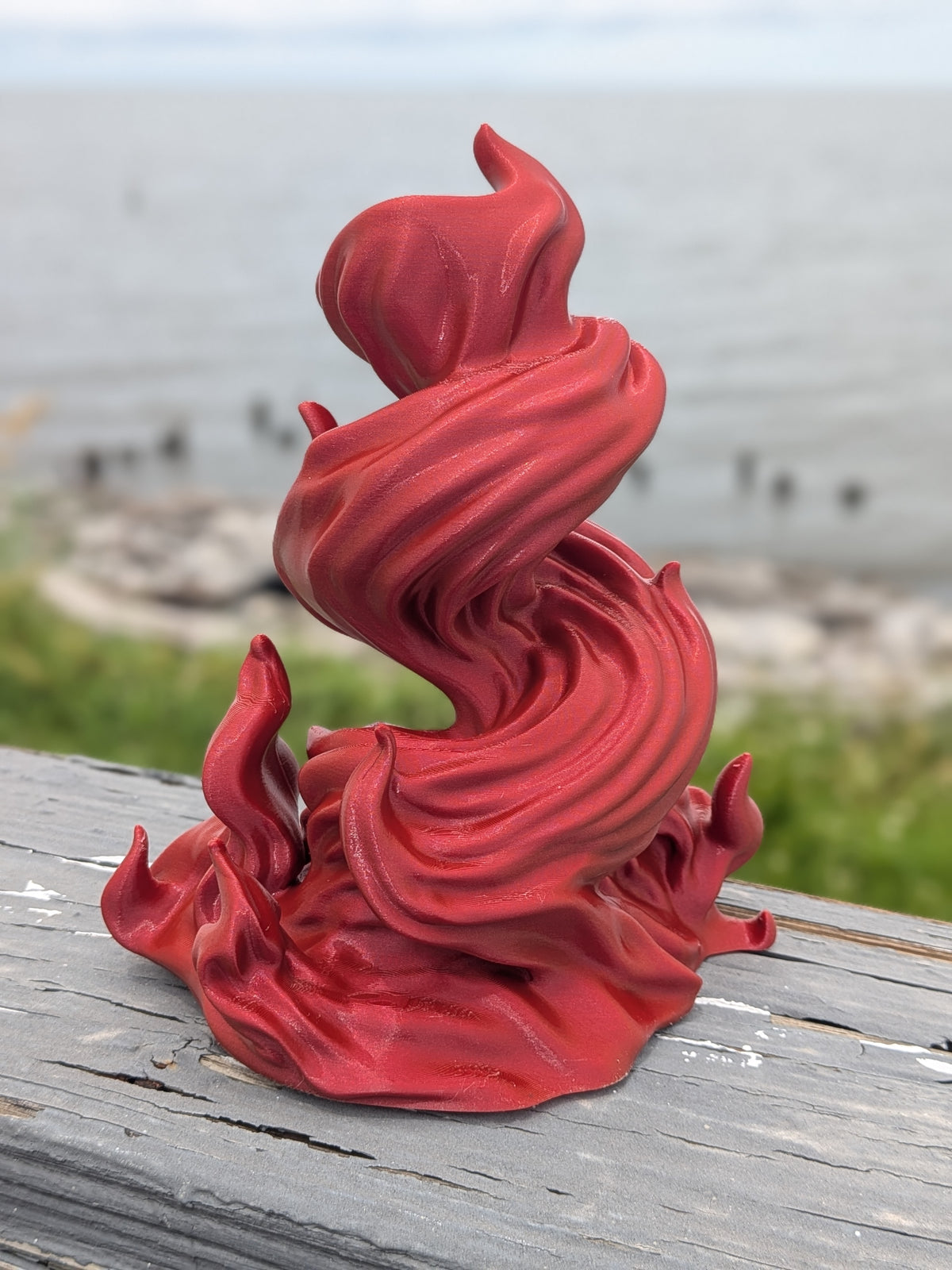 Side angle of the flame dice tower with flickering fire-shaped base
