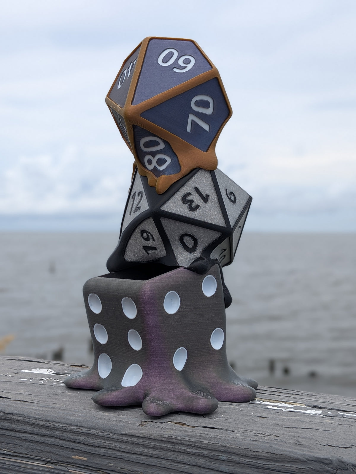 Melting dice planter showing the D20 and D6 dice mid-drip into the rocky base