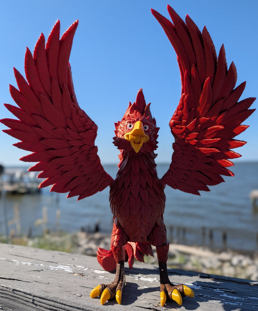 Articulated phoenix figure with wings spread, standing on a wood railing