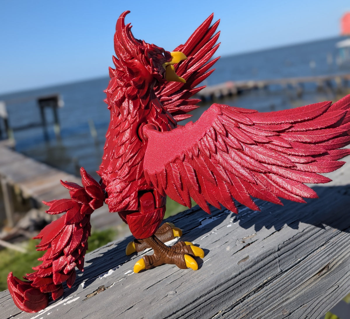 Articulated phoenix figure, side view showing posed legs and tail