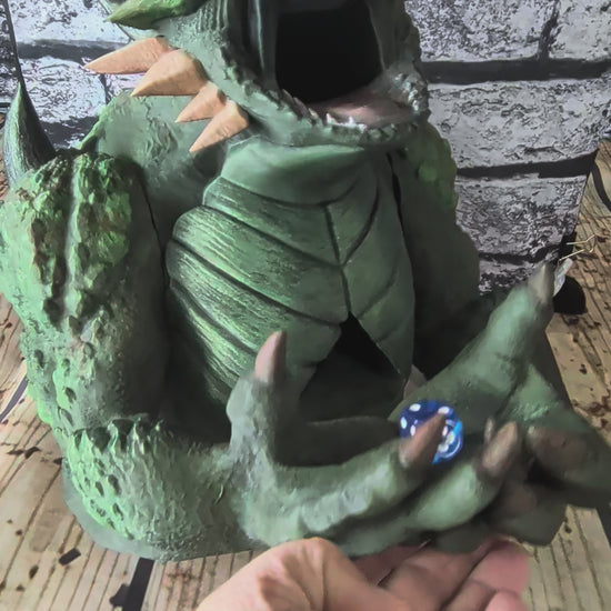 Hand-painted green devourer dice tower with open jaws and claws in its lap
