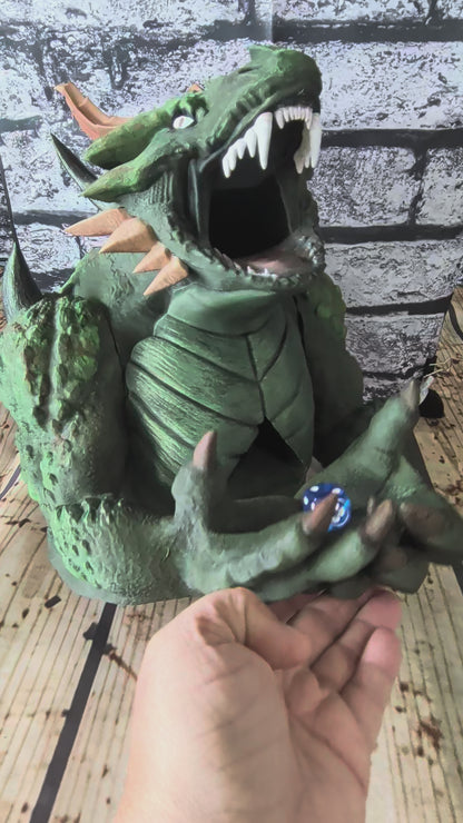 Hand-painted green devourer dice tower with open jaws and claws in its lap