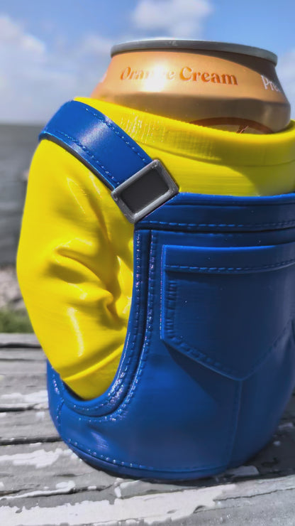 3D-printed can holder shaped like a yellow character in blue overalls, holding a soda can on a dock railing