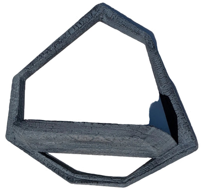 A dark gray, geometric, open-frame shelf or planter with a textured, layered finish, shown on a light marble surface.