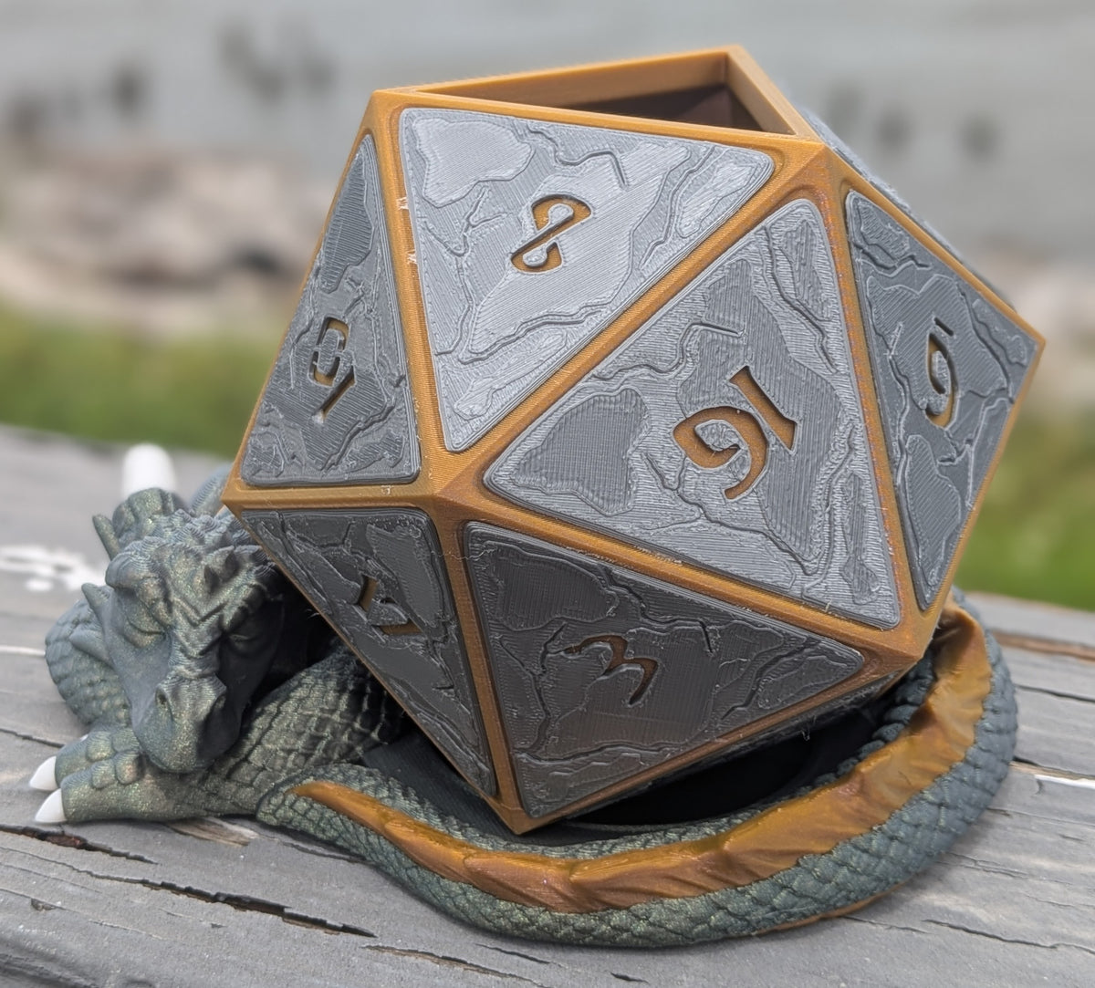 Sleeping dragon coiled around a giant D20 dice planter, front view