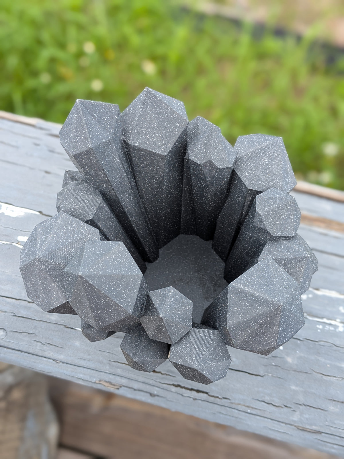 Crystal cluster vase displayed outdoors on a wood surface