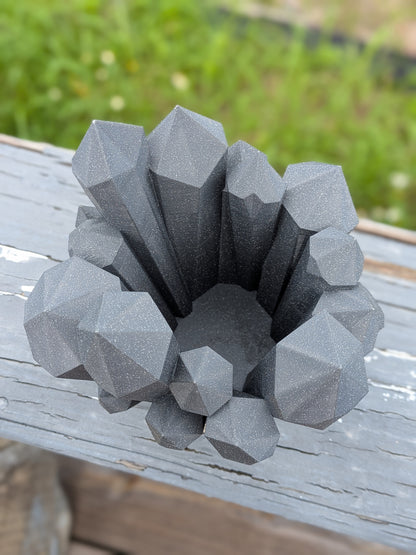 Crystal cluster vase displayed outdoors on a wood surface